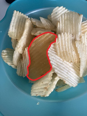 there's a really brown chip in this bowl of ruffles